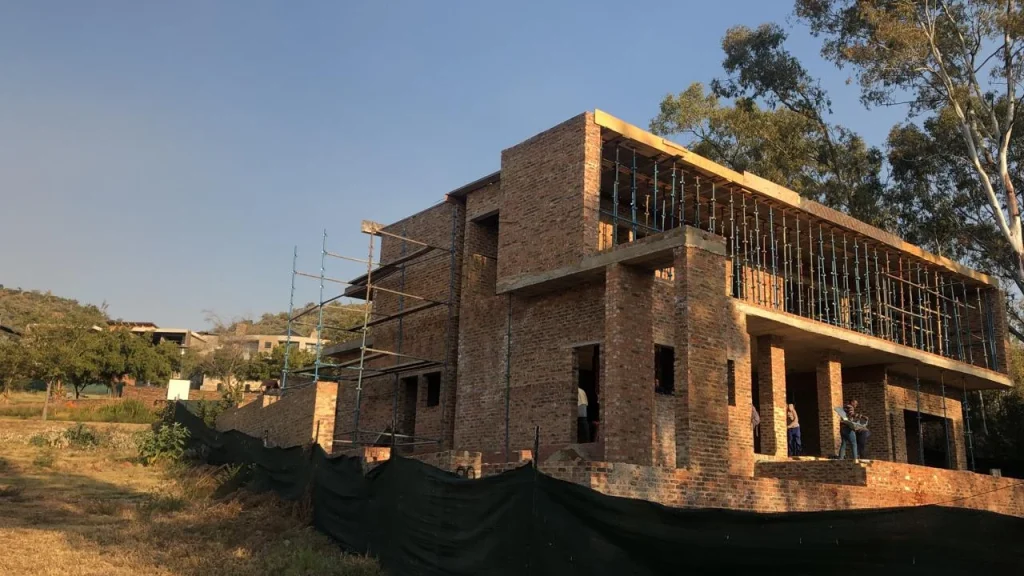 Sugarbush Residence — site progress showing the double-storey structure within its golf-estate setting